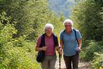 An active senior couple hiking in nature, symbolizing healthy aging and longevity.
